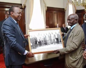 President Uhuru Kenyatta awarding city businessman, Mzee Gerald Gikonyo at State House at a past event. (Tuko)