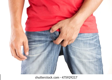 man holding his crotch